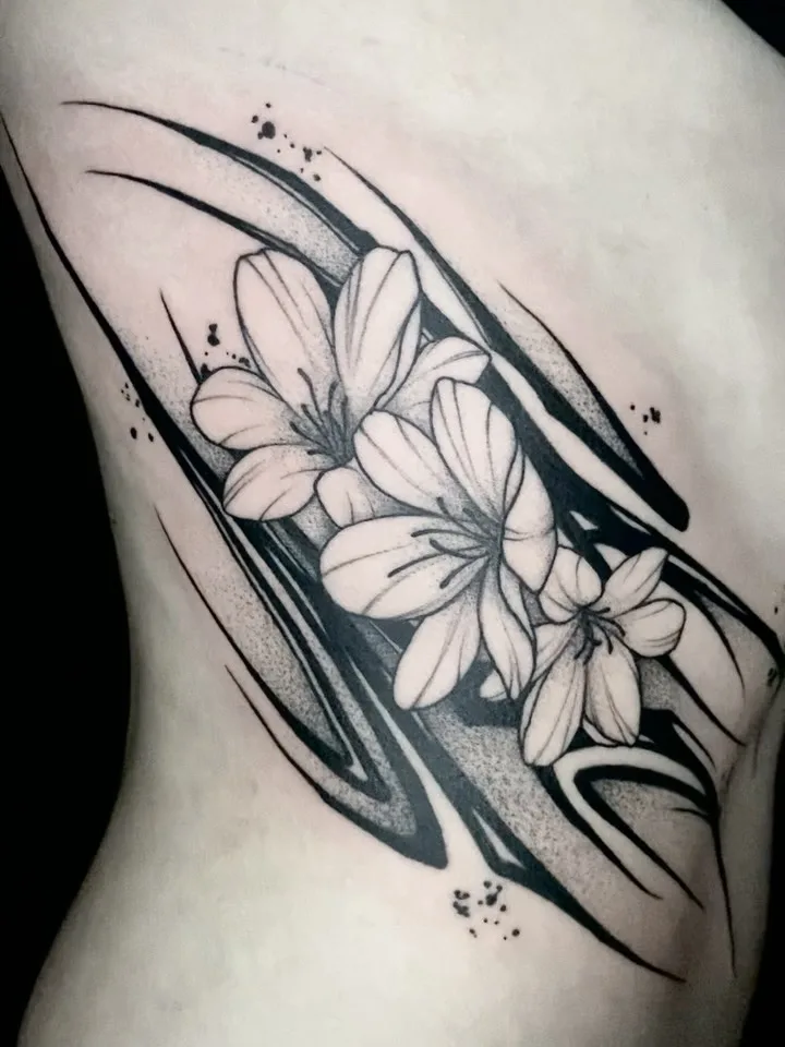 Black and grey lilies over an abstract brush-stroke background on the ribs
