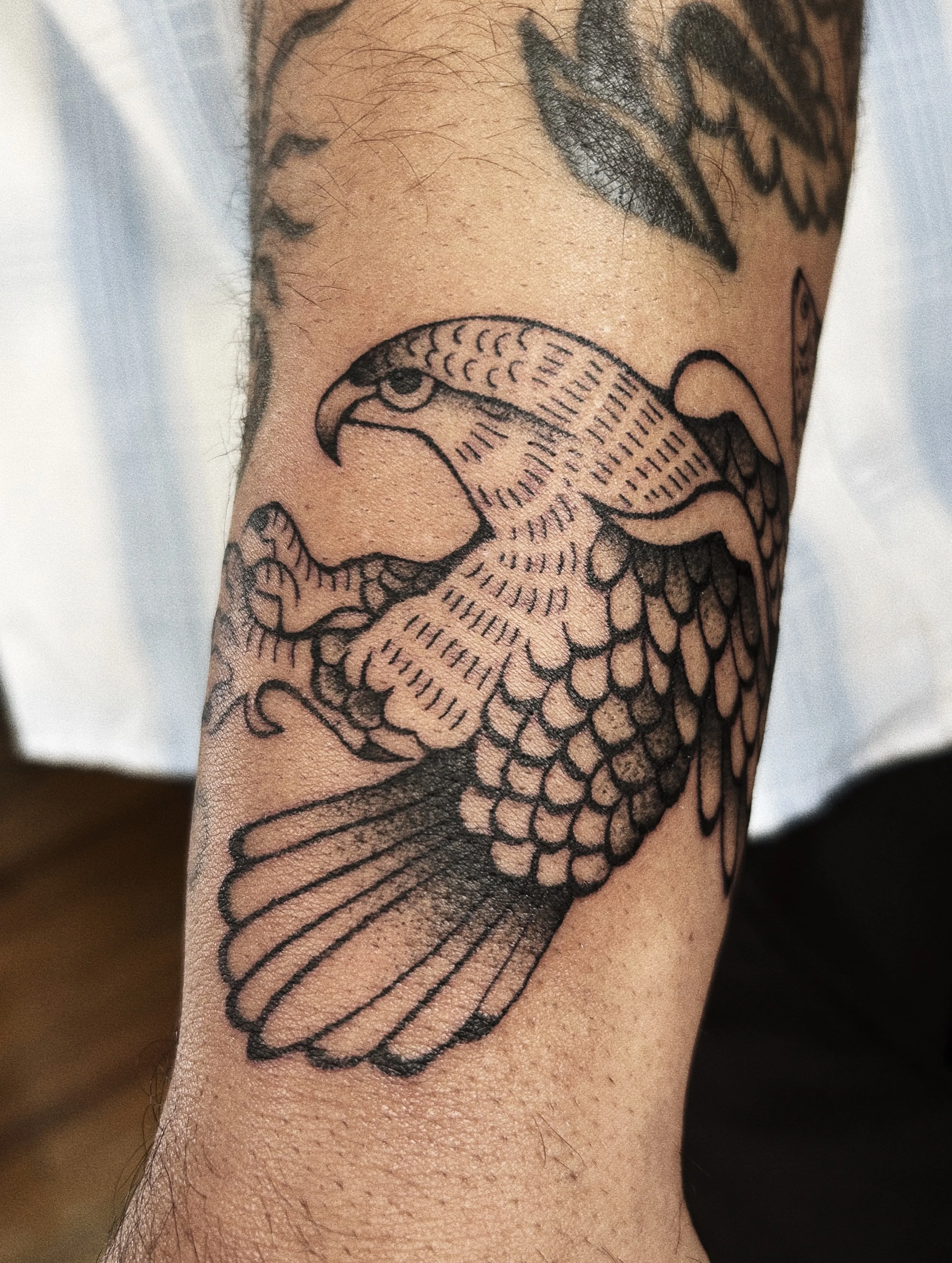 Bold black traditional eagle wings spread on the inner arm