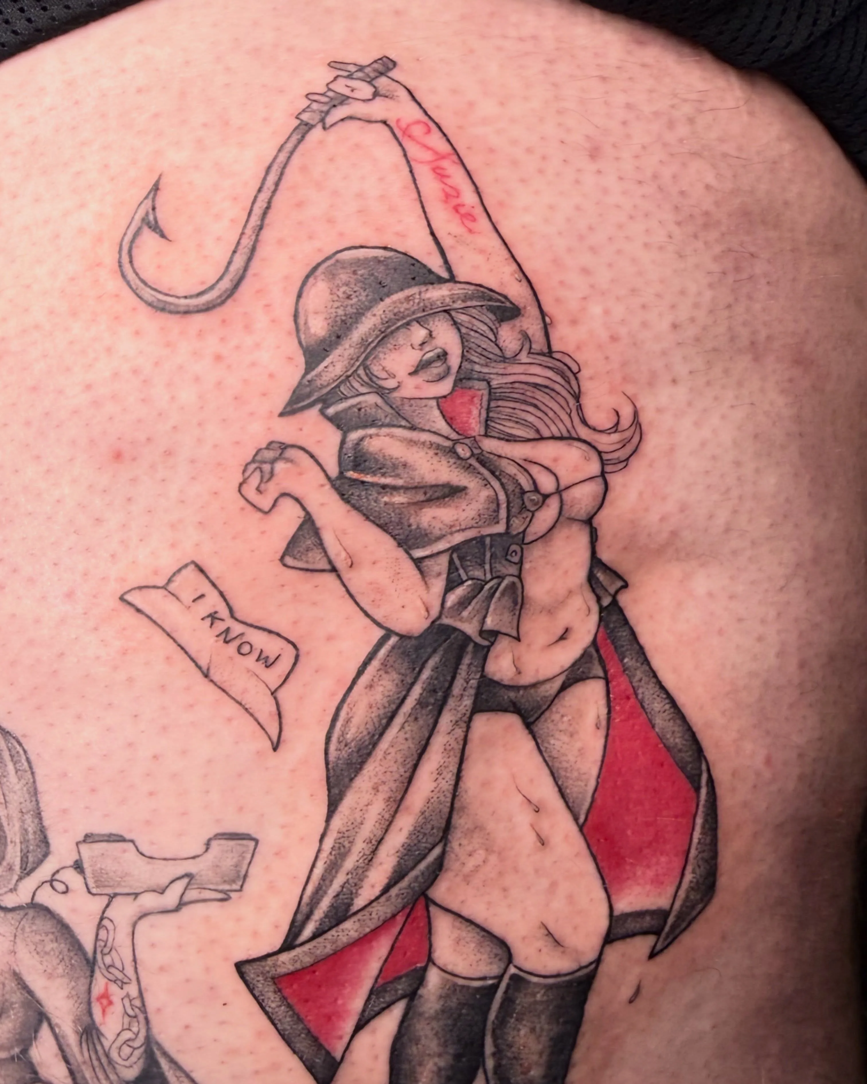 Black, grey and red back tattoo — caped figure with a dramatic banner